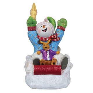 Decorative ornament of a snowman with a dog on a sled, on a white background