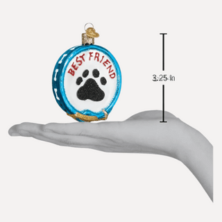 Decorative ornament with 'Best Friend' and paw print on a blue background, held in a hand for scale.