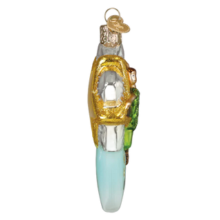 Decorative glass ornament of a lighthouse on a white background