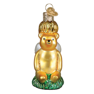 Gold bear ornament with a hat on a white background