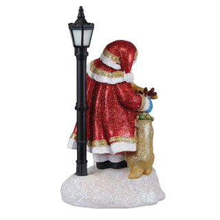 Decorative figure of a person in a red coat standing next to a black lamp post on a white background