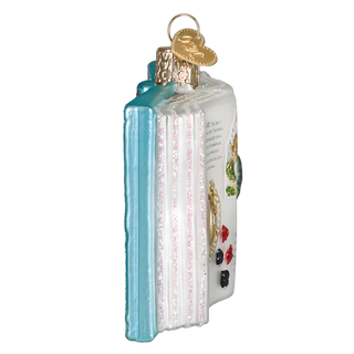 Decorative glass book ornament with colorful illustrations on a white background