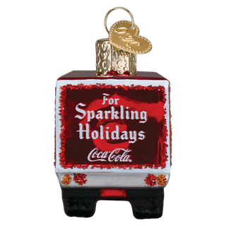 Coca-Cola Christmas ornament shaped like a cooler with 'For Sparkling Holidays' text on a white background.